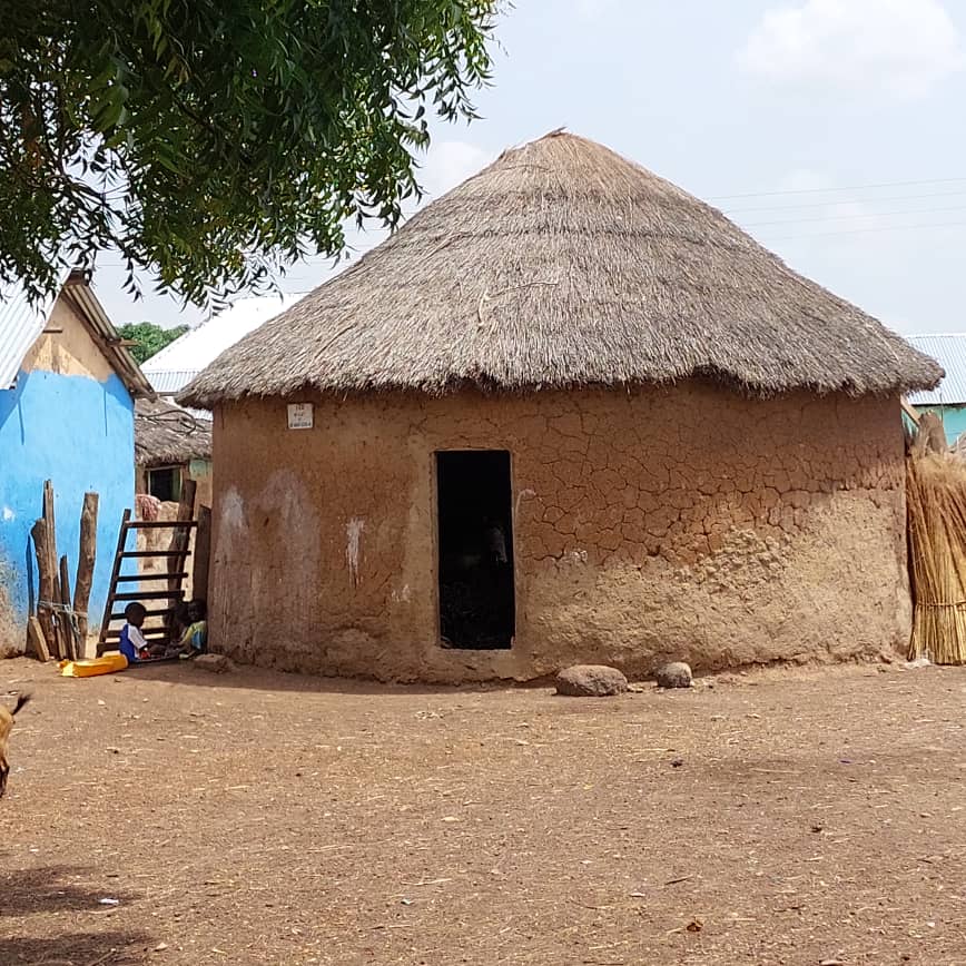 Earthen roundhouse with a thatched roof in a village in Northern Ghana