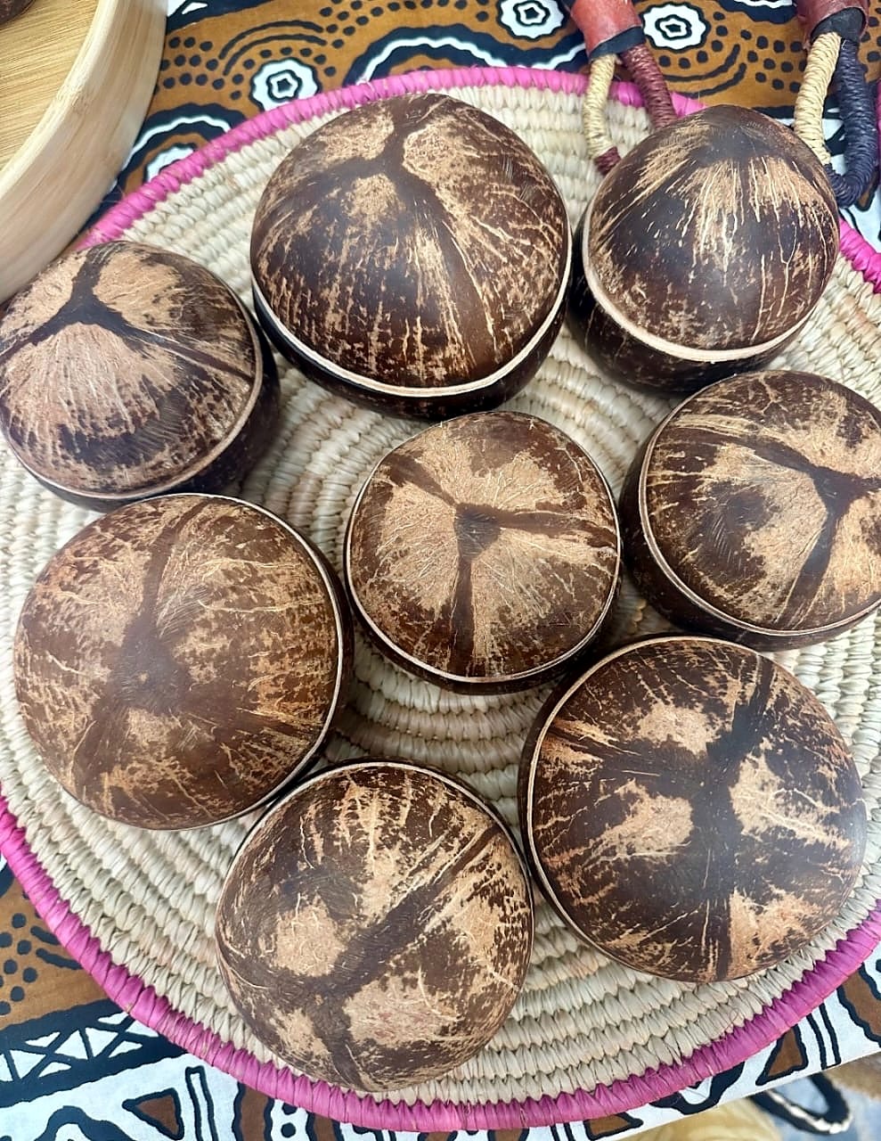 BOKOO whipped shea butter: closed natural coconut-shell bowls with lids, arranged in a woven basket
